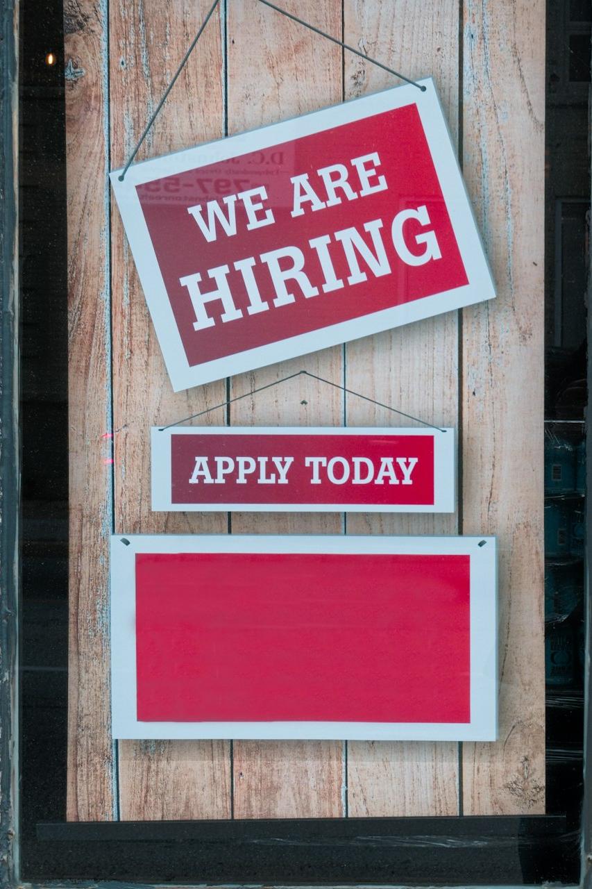 a sign that says we are hiring and apply today
